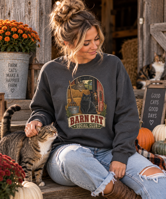 Woman wearing the Barn Cat Social Club crewneck while petting a barn cat